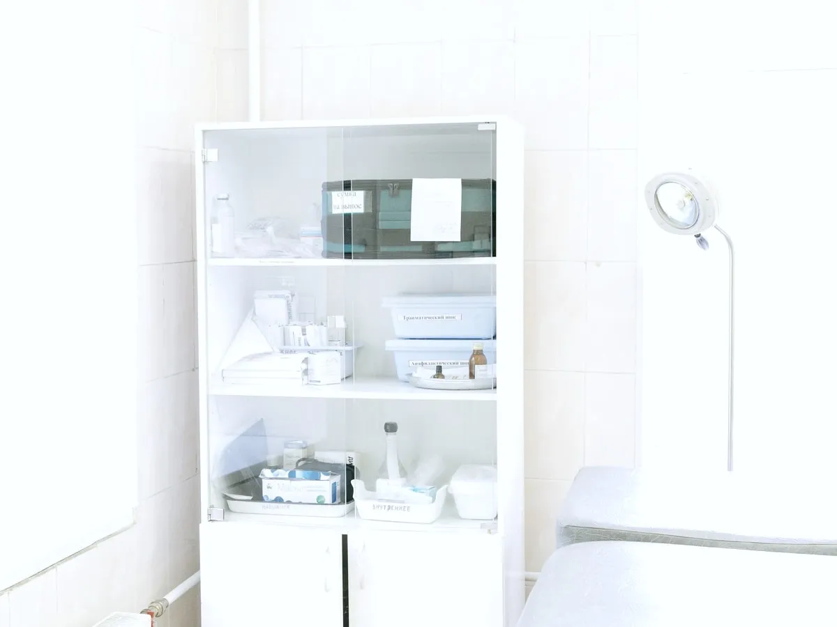 A glass-fronted cabinet of clinic supplies.