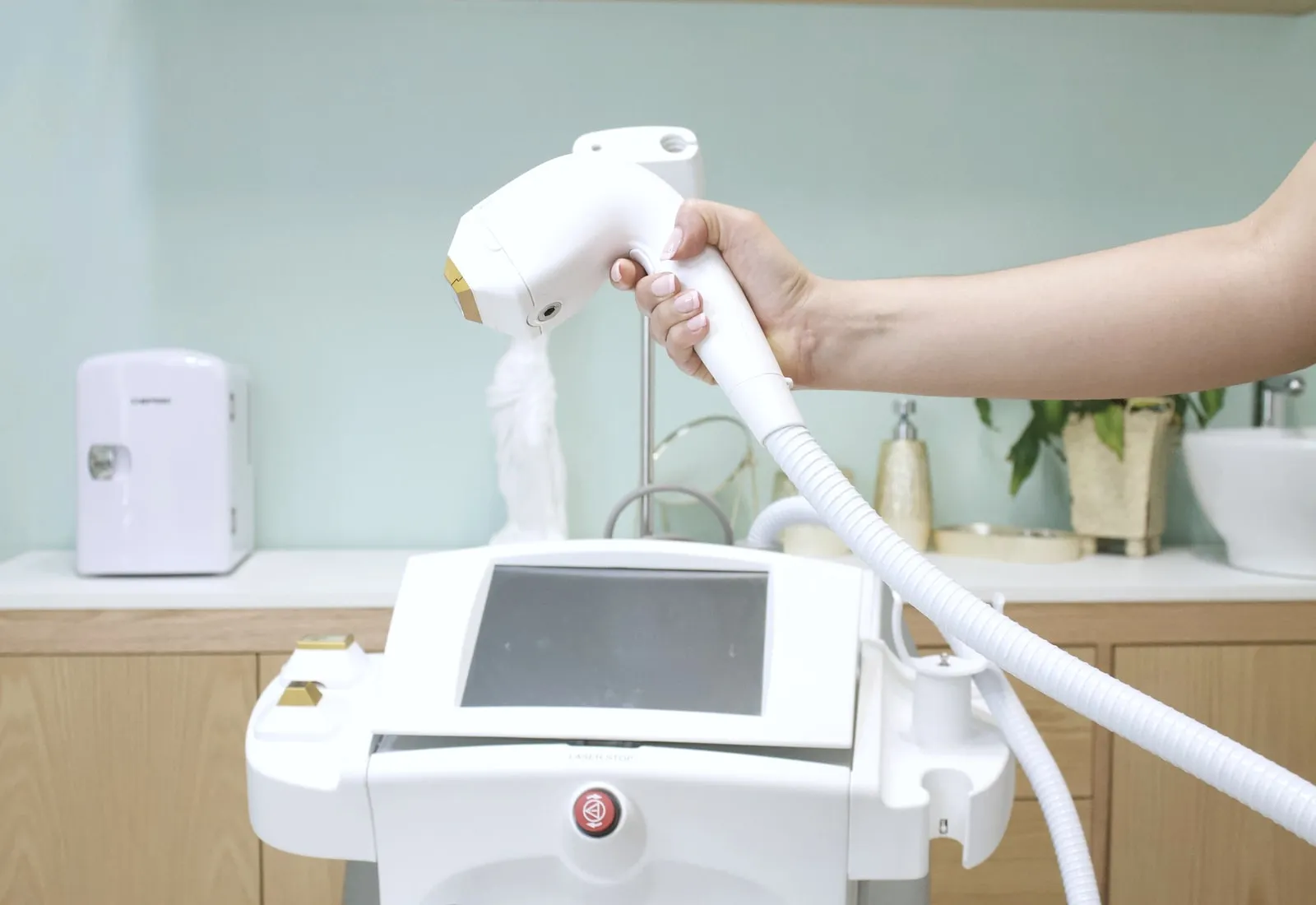 The hair-removal handpiece held over the treatment couch.