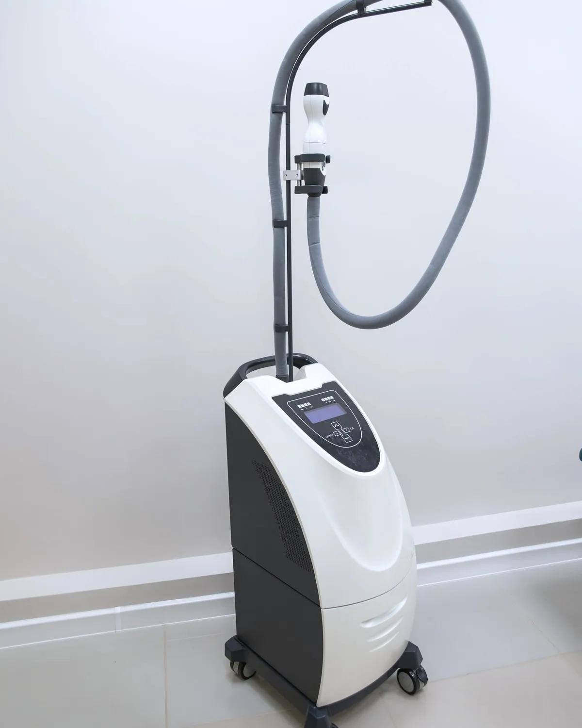 The resurfacing laser standing beside the treatment couch.